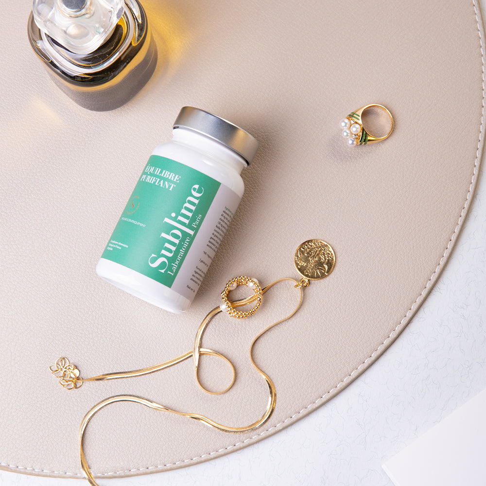 Laboratoire Sublime Purifying Balance detox supplement bottle with jewelry, French liver cleanse and skin detox formula, flat lay lifestyle view.