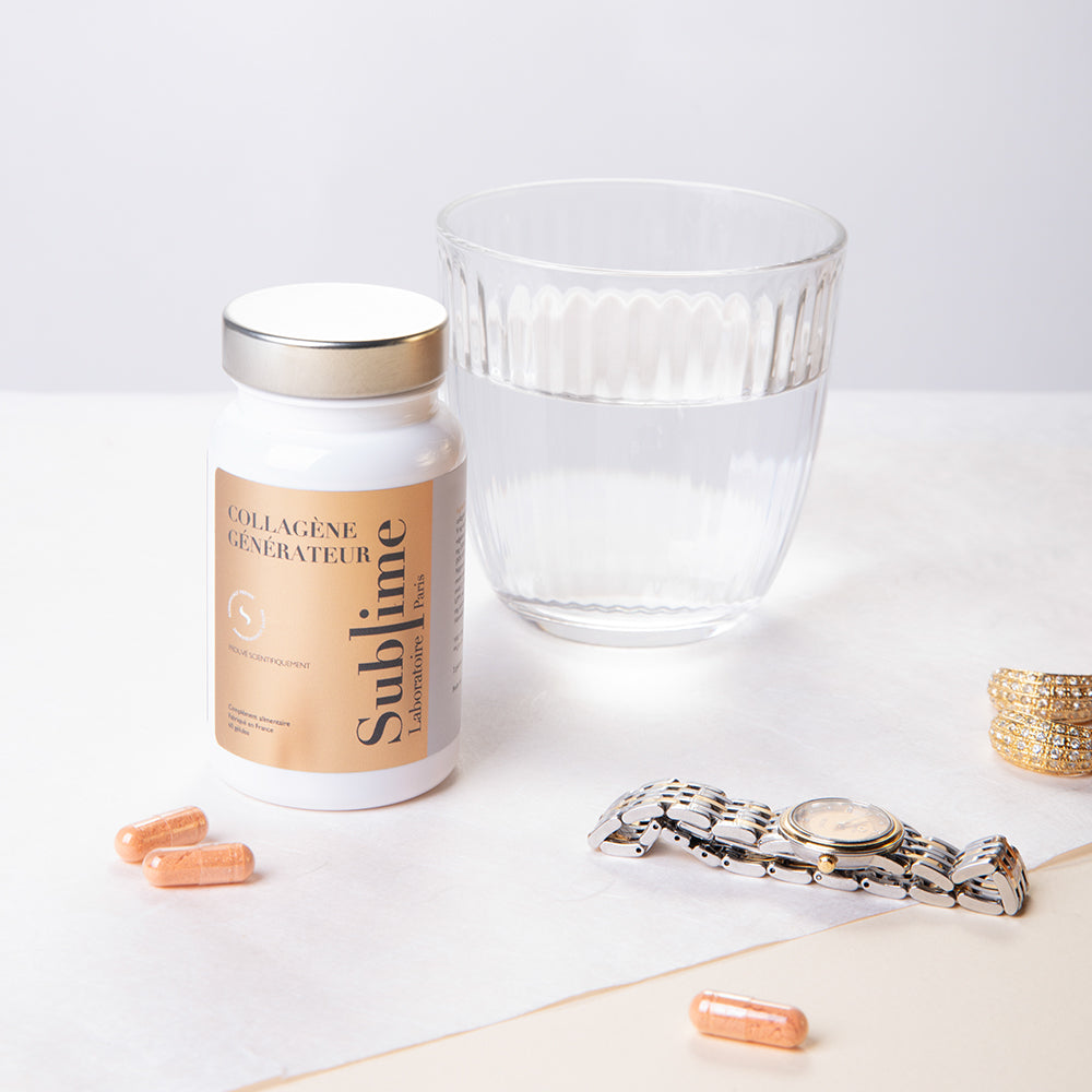 Laboratoire Sublime Regenerated Radiance collagen supplement bottle with capsules, glass of water, and gold jewelry on a soft beige background, French anti-aging beauty nutrition.
