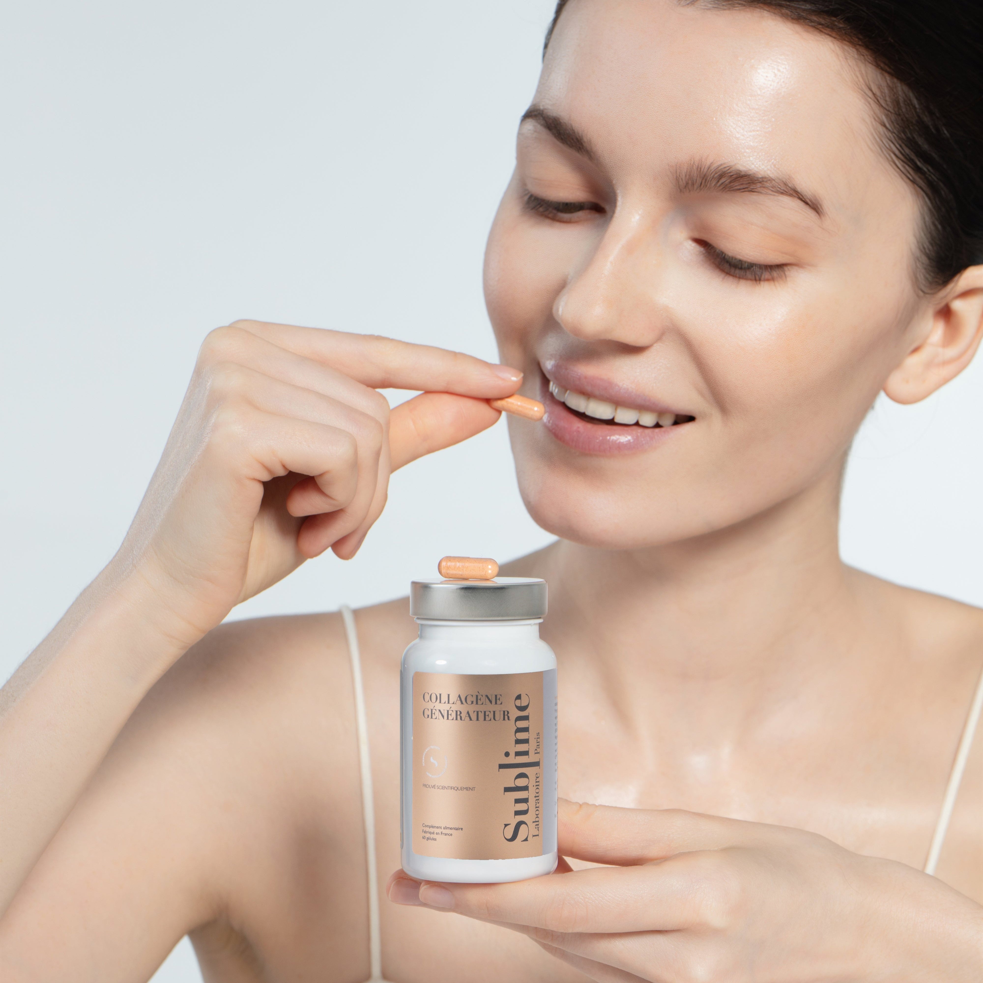 Woman holding Laboratoire Sublime Rejuva Collagen bottle and collagen capsule, French beauty supplement for skin glow, front portrait on white background.
